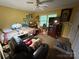 Bedroom featuring cozy seating, a large ceiling fan, a comfortable bed, and a view to the exterior through a window at 5198 Wright Dr, Hickory, NC 28602