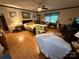 Comfortable bedroom with a bed, seating area, wood-look flooring, and natural light from a window at 5198 Wright Dr, Hickory, NC 28602