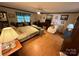 Comfortable bedroom with a bed, seating area, wood-look flooring, and natural light from a window at 5198 Wright Dr, Hickory, NC 28602