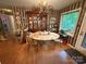 Cozy dining area featuring an elegant chandelier, wood floors, and abundant natural light from a large window at 5198 Wright Dr, Hickory, NC 28602