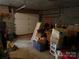 Storage space with garage door, brick wall, and various stored belongings and boxes at 5198 Wright Dr, Hickory, NC 28602