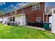 View of a brick condo backyard with well maintained lawns and black patio furniture at 556 Knighton Hill Rd, Rock Hill, SC 29732