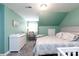 Cozy bedroom featuring soft green walls, plush carpeting, a comfortable bed, and a crib at 556 Knighton Hill Rd, Rock Hill, SC 29732