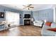 Bright living room with a fireplace, hardwood floors, and blue walls at 556 Knighton Hill Rd, Rock Hill, SC 29732