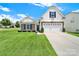 Charming curb appeal is exhibited in the two-story home with a manicured lawn and stone details at 6192 Kilchurn Dr, Fort Mill, SC 29707