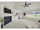 Open living space with fireplace, mounted TV, and views of the dining area and backyard at 6192 Kilchurn Dr, Fort Mill, SC 29707