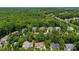 Aerial view of neighborhood with homes nestled among lush, green trees at 6300 Latta Springs Cir, Huntersville, NC 28078