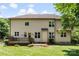 A two-story home with a wooden deck overlooking the green backyard and mature trees at 6300 Latta Springs Cir, Huntersville, NC 28078