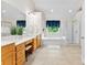 Bright bathroom featuring a soaking tub, glass shower, and a vanity with double sinks at 6300 Latta Springs Cir, Huntersville, NC 28078