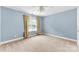Spacious bedroom with pale blue walls, neutral carpet and a large window at 6300 Latta Springs Cir, Huntersville, NC 28078