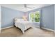 Cozy bedroom with a ceiling fan, neutral carpet, and a large window at 6300 Latta Springs Cir, Huntersville, NC 28078