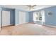 Bedroom with a large window with white curtains, a closet, and light blue walls at 6300 Latta Springs Cir, Huntersville, NC 28078