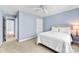 Light-filled bedroom with pale blue walls, neutral carpet and a comfortable bed at 6300 Latta Springs Cir, Huntersville, NC 28078