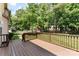 Large wooden deck with railing that overlooks a nice backyard with mature trees and playset at 6300 Latta Springs Cir, Huntersville, NC 28078
