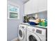 Convenient laundry room with washer, dryer, and storage cabinets, making laundry chores a breeze and keeping organized at 6300 Latta Springs Cir, Huntersville, NC 28078