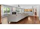 Cozy living room with a fireplace, hardwood floors, and ample windows at 6300 Latta Springs Cir, Huntersville, NC 28078