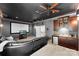 The living room features dark gray walls, a mini bar, ceiling fan and a screen projector at 6300 Latta Springs Cir, Huntersville, NC 28078