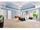 Bright main bedroom with tray ceiling and ample natural light, offering a peaceful sanctuary for rest and rejuvenation at 6300 Latta Springs Cir, Huntersville, NC 28078