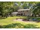 Expansive backyard features a fire pit and a charming outdoor seating area for entertaining and relaxation at 7015 Lavern St, Charlotte, NC 28215