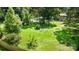Expansive backyard with mature trees, fire pit area, and garden beds, perfect for outdoor living and entertaining at 7015 Lavern St, Charlotte, NC 28215