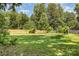 Secluded backyard is surrounded by lush greenery and wooden fencing, offering privacy and a tranquil atmosphere at 7015 Lavern St, Charlotte, NC 28215
