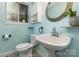 Charming bathroom with a pedestal sink, patterned tile floors, and a bright window at 7015 Lavern St, Charlotte, NC 28215