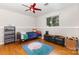 Nicely furnished bedroom with wood floors, ceiling fan, and good natural light at 7015 Lavern St, Charlotte, NC 28215