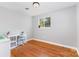 A small, spare bedroom or home office with hardwood floors and window for natural light at 7015 Lavern St, Charlotte, NC 28215