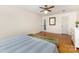 Spacious bedroom with hardwood floors, a ceiling fan, and a bench at the foot of the bed at 7015 Lavern St, Charlotte, NC 28215
