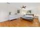 Bright bedroom with hardwood floors, a ceiling fan, and a large dresser for ample storage at 7015 Lavern St, Charlotte, NC 28215