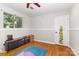 Bedroom with hardwood floors, window, and fun decorations at 7015 Lavern St, Charlotte, NC 28215