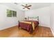 Cozy bedroom featuring hardwood floors, window, and a comfortable-looking bed at 7015 Lavern St, Charlotte, NC 28215