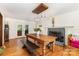 Bright dining area with hardwood floors, modern lighting, and a fireplace, creating an inviting space at 7015 Lavern St, Charlotte, NC 28215
