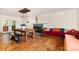 Sunlit dining room with hardwood floors, fireplace, a wooden dining table with bench and unique decor at 7015 Lavern St, Charlotte, NC 28215