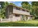 A charming two-story home featuring classic design, red shutters, and a well-maintained front yard with mature trees at 7015 Lavern St, Charlotte, NC 28215
