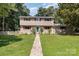 Charming two-story home with a well-maintained lawn and pathway leading to a welcoming front entrance at 7015 Lavern St, Charlotte, NC 28215