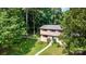 Charming two-story home with a well-manicured lawn, a white picket fence, and mature trees in the front yard at 7015 Lavern St, Charlotte, NC 28215