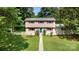 Charming two-story home with red shutter details, a well-manicured lawn, and a welcoming front entrance at 7015 Lavern St, Charlotte, NC 28215