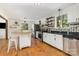 Bright kitchen with stainless steel appliances, granite countertops, an island with seating, and hardwood floors at 7015 Lavern St, Charlotte, NC 28215