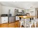 Bright kitchen features an island with bar seating, stainless steel appliances and white cabinetry at 7015 Lavern St, Charlotte, NC 28215