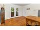 Open living area featuring hardwood floors, French doors to the porch, and a view of the backyard at 7015 Lavern St, Charlotte, NC 28215