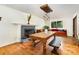 Open-concept living room boasts hardwood floors, a fireplace, a unique dining table, and ample natural light at 7015 Lavern St, Charlotte, NC 28215