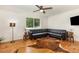 Cozy living room with hardwood floors, a large window, and comfortable black leather sectional sofa at 7015 Lavern St, Charlotte, NC 28215
