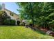 Landscaped backyard showing mature trees, plants, and grass, providing privacy at 8619 New Oak Ln, Huntersville, NC 28078