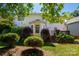 View of the home's exterior from the backyard, with mature trees and landscaping at 8619 New Oak Ln, Huntersville, NC 28078