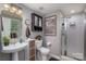 Clean bathroom with a walk-in shower, vanity, and sleek fixtures at 8619 New Oak Ln, Huntersville, NC 28078