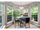 Cozy breakfast nook surrounded by windows, creating a cheerful dining space at 8619 New Oak Ln, Huntersville, NC 28078