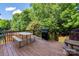 Spacious wooden deck with picnic table and BBQ grill, perfect for outdoor entertaining at 8619 New Oak Ln, Huntersville, NC 28078