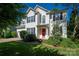 Charming two-story home with a manicured lawn and bright red front door at 8619 New Oak Ln, Huntersville, NC 28078