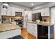 Well-lit kitchen showcases granite countertops, stainless steel appliances, and white cabinets at 8619 New Oak Ln, Huntersville, NC 28078